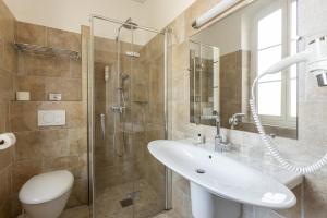 a bathroom with a toilet and a sink and a shower at Villa Sainte Anne in Porquerolles