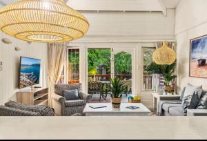 a large living room with a large chandelier at Knysna Lagoon - Summer Breeze in Knysna