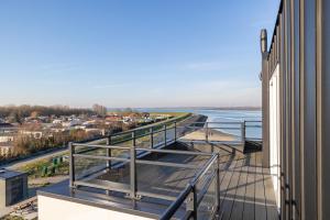 a balcony of a building with a view of the water at Vakantiewoning aan het water - met dakterras en balkon - Vista Maris - Nr 48 in Sint Annaland