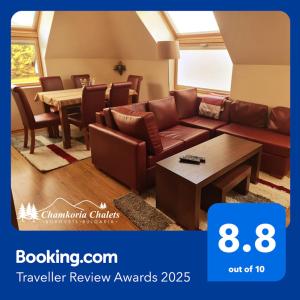 a living room with a couch and a table at Chamkoria Chalets 409 in Borovets