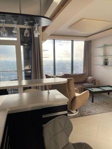 a living room with a couch and a table at Sky-scraper in Klaipėda