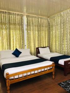 two beds sitting next to each other in a room at Ghala Homestay in Anachal