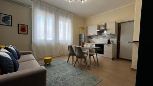a living room with a couch and a table and a kitchen at Le Dimore del Corso in Catania