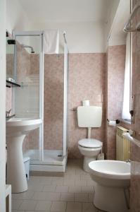 a bathroom with a shower and a toilet and a sink at Hotel Capriolo in Vidiciatico