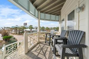 three chairs on a porch with a view of the beach at Calypso Breeze in Gulf Shores