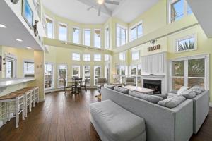 a large living room with a couch and a fireplace at Calypso Breeze in Gulf Shores +54 photos