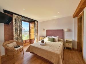 a bedroom with a bed and a large window at La Casita Azul - 1003 in Arnuero