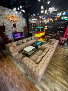 a living room with a couch and a table at Riverside Hoi An, Dolphins Hostel in Hoi An