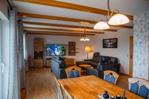 a living room with a couch and a table at Ferienhaus Pauly in Bergen