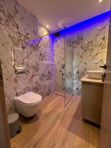 a bathroom with a toilet and a sink and a shower at Adas Aura - Boutique Apartments in Old Town Thessaloniki in Thessaloniki +39 photos
