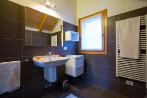 a bathroom with a sink and a toilet and a window at house with 3 bedrooms T5 in Bellano +16 photos