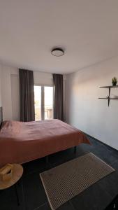 a bedroom with a large bed and a window at Piso Bosique in San Pedro del Pinatar +15 photos