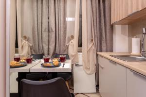 a kitchen with a table with two plates of food at Oliviero - Piazza Navona Suite in Rome