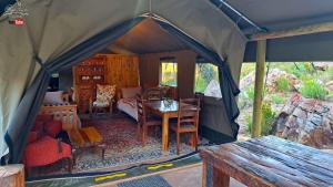 a tent with a table and chairs in it at BaliesGat Accommodation and Camping in De Straat