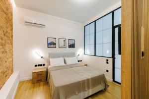 a bedroom with a bed and a large window at G Residence in Athens