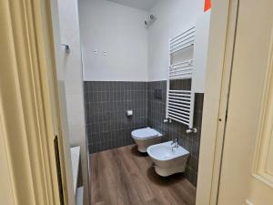 a bathroom with a toilet and a sink in it at Be Your Home - Olilà in Civitavecchia +29 photos