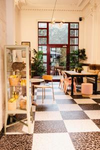 a room with a checkered floor and a table and chairs at Wombat's City Hostel Leipzig in Leipzig +85 photos