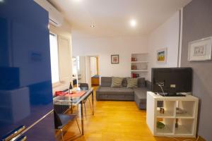 a living room with a couch and a tv at Cozy 2BR Apartment near Piazza Navona in Rome