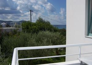 a view of the ocean from a balcony of a house at Hotel Plakures in Falasarna