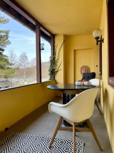 a room with a table and a chair and a window at Urlaub in der Eifel direkt am Rursee - Seeblick in Simmerath
