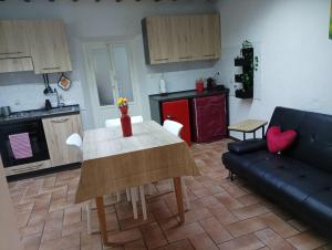 a kitchen and living room with a table and a couch at La Finestra Sul Fiume in Subbiano +12 photos
