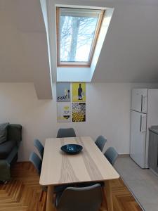 a dining room with a table and a window at SND Aparts in Novi Sad