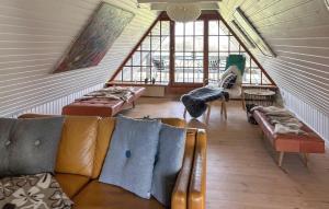 a living room with couches and tables and windows at Awesome Home In Nordborg With Sauna in Nordborg +14 photos