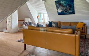 a living room with a brown leather couch at Awesome Home In Nordborg With Sauna in Nordborg