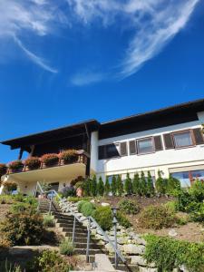 a house with stairs and plants in front of it at Ferienwohnung Panoramablick in Wertach
