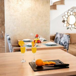 a dining room table with glasses of orange juice at Holiday house Lucy in Žgaljić