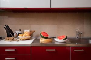 a kitchen counter with a sink and fruits and vegetables at La Rosa Del Mare in La Maddalena