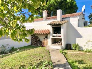 a white house with a garage in the yard at Maison familiale 3 chambres proche de la plage, jardin & tranquillité in Saint-Denis-dʼOléron
