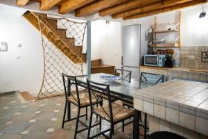 a kitchen with a table and chairs and a refrigerator at Dimora del Pescatore - apeliving- Pellestrina Ve in Pellestrina