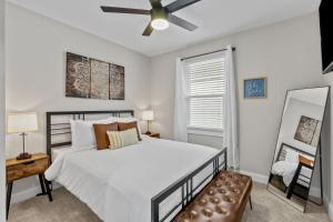 a bedroom with a bed and a ceiling fan at 4456 Blue Door Bungalow in Southhampton