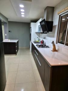 a kitchen with a stove and a counter top at Casa Lupe - Con Piscina Climatizada in Las Heras