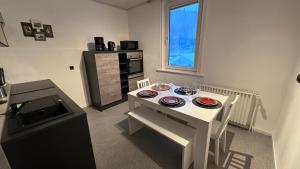 a kitchen with a white table with plates on it at Spar die Müh in Langelsheim