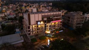 an overhead view of a building in a city at night at Hillside Hotel in Mysore