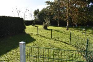 a fence in the middle of a field at Ferienwohnung Labradoodle in Dornum
