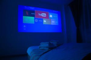 a dark room with a tv in a blue room at LZR - Apartment 57 in Braşov +3 photos