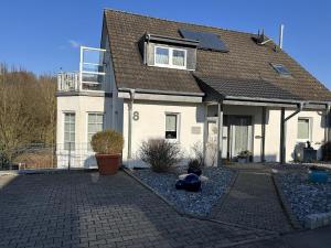 a white house with a roof at Apartment Wallberg "Nest" in Detmold
