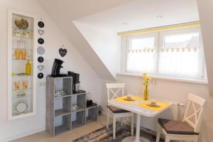 a dining room with a table and chairs and a window at Apartment Wallberg "Nest" in Detmold +11 photos
