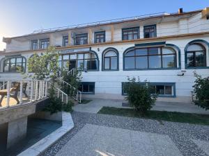 a large white building with windows and a balcony at Elazığ Mavigöl Otel in Sivrice
