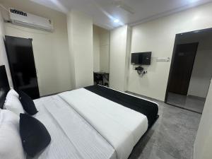 a bedroom with a large white bed in a room at Star light in Nagpur