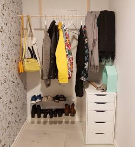 a walk in closet with clothes and shoes at Lovely sea view in modern family house! in Steinkjer