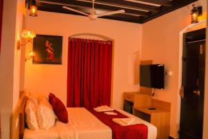 Postel nebo postele na pokoji v ubytování Hotel Chithrapuri