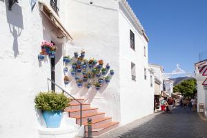 a street with potted plants on the side of a building at New Apartment With Stunning Views in Mijas