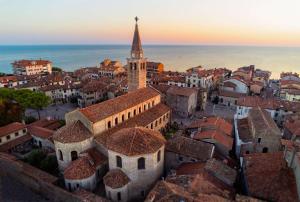 an aerial view of a city with a clock tower at Costa Azzurra Apartment in Grado