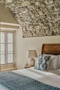 a bedroom with a bed with a floral pillow and a window at Villa Issima "The Castello Suite" - Menaggio by LoveComo in Menaggio +17 photos