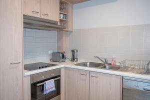 a small kitchen with a sink and a stove at Contemporary 2BR apartment near Kingston - Hosted by Canstay in Kingston 