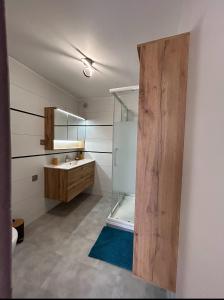 a bathroom with a glass shower and a sink at Gîte Nature & Volcans in Volvic